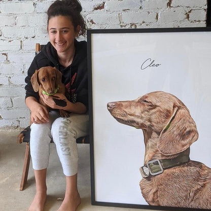 Customer sitting with brown Dachshund next to a large framed custom realistic pet portrait named Cleo.